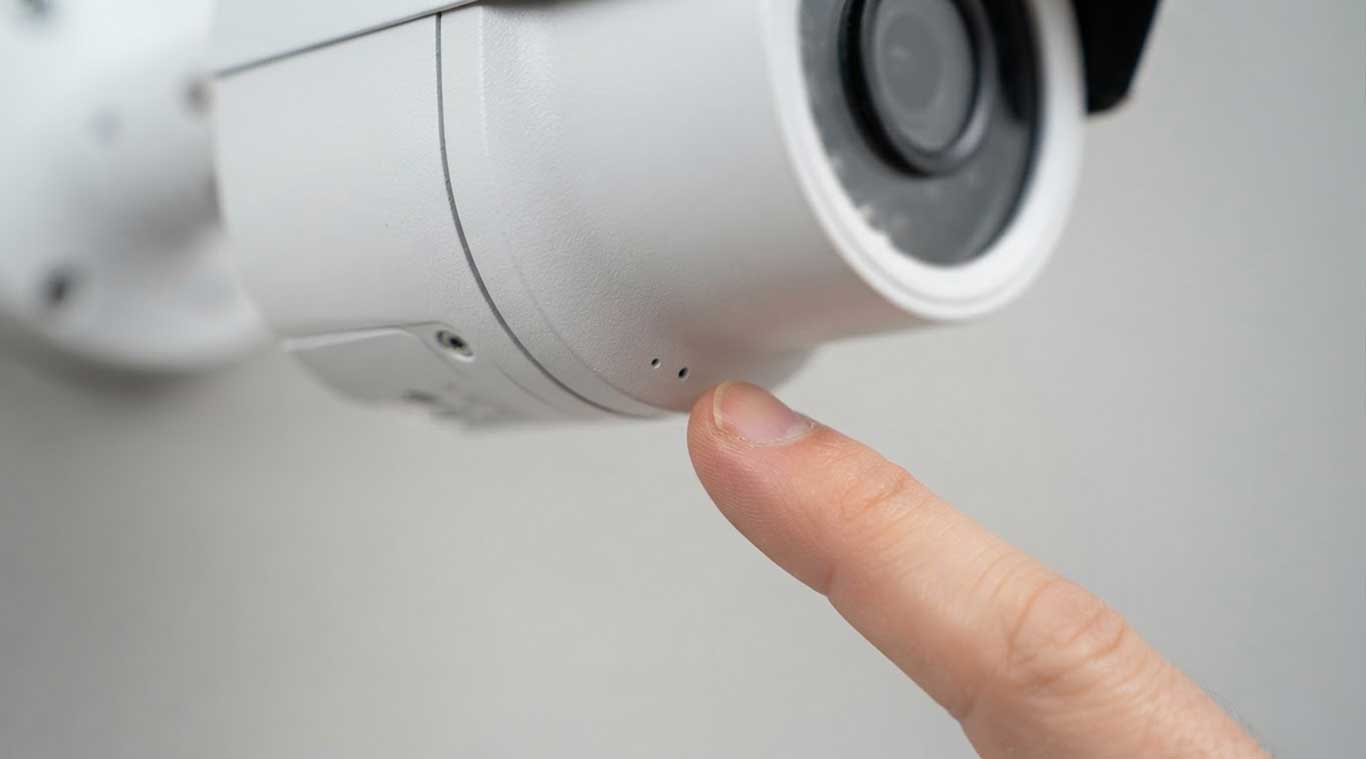 Close-up of a security camera showing its microphone opening